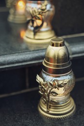 Photo of Grave lights on granite surface at cemetery