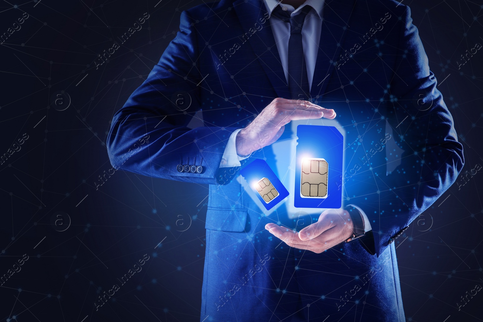 Image of Man demonstrating SIM cards of different sizes on dark background, closeup 