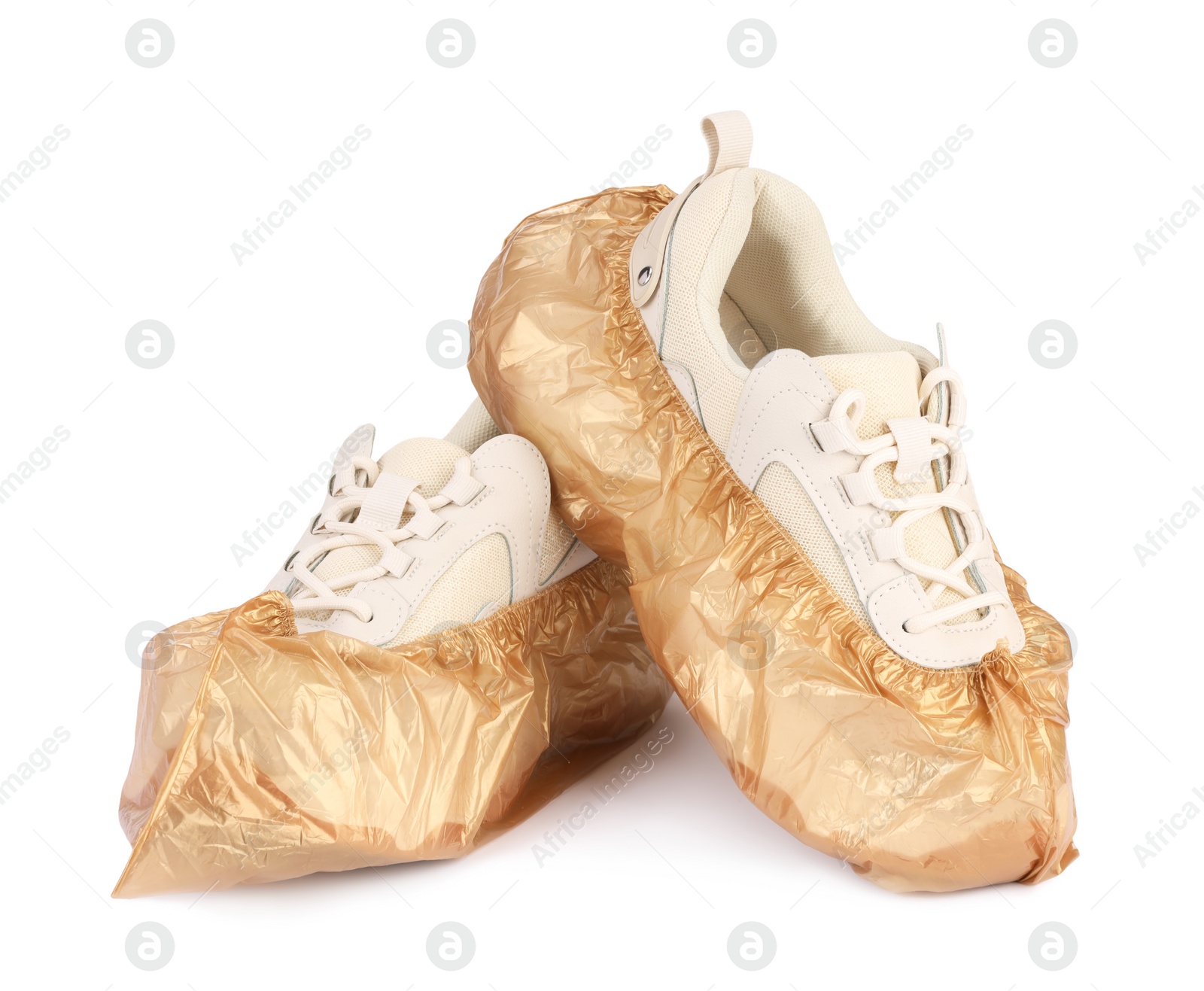 Photo of Sneakers in brown shoe covers isolated on white