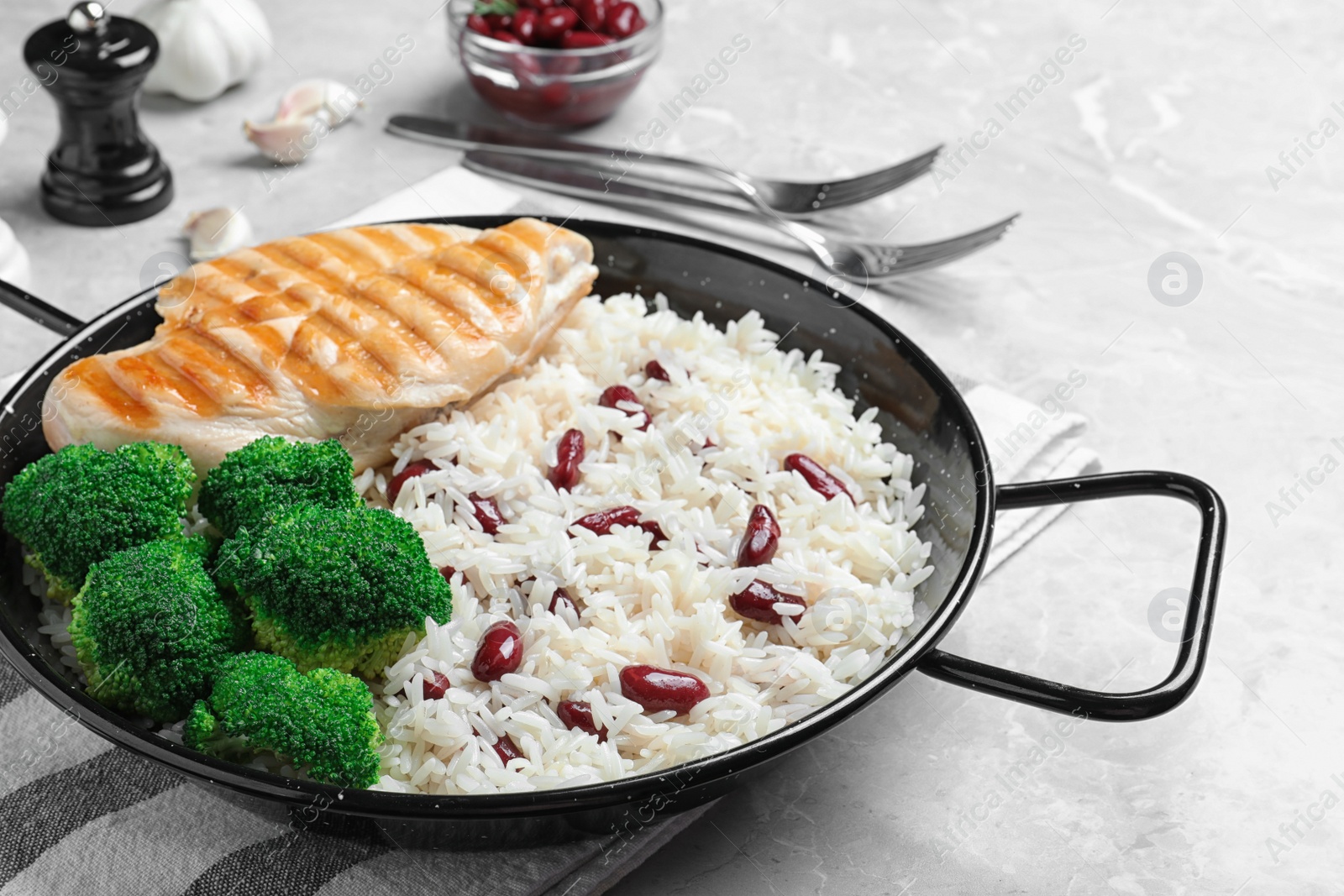 Photo of Tasty rice with beans on light grey marble table