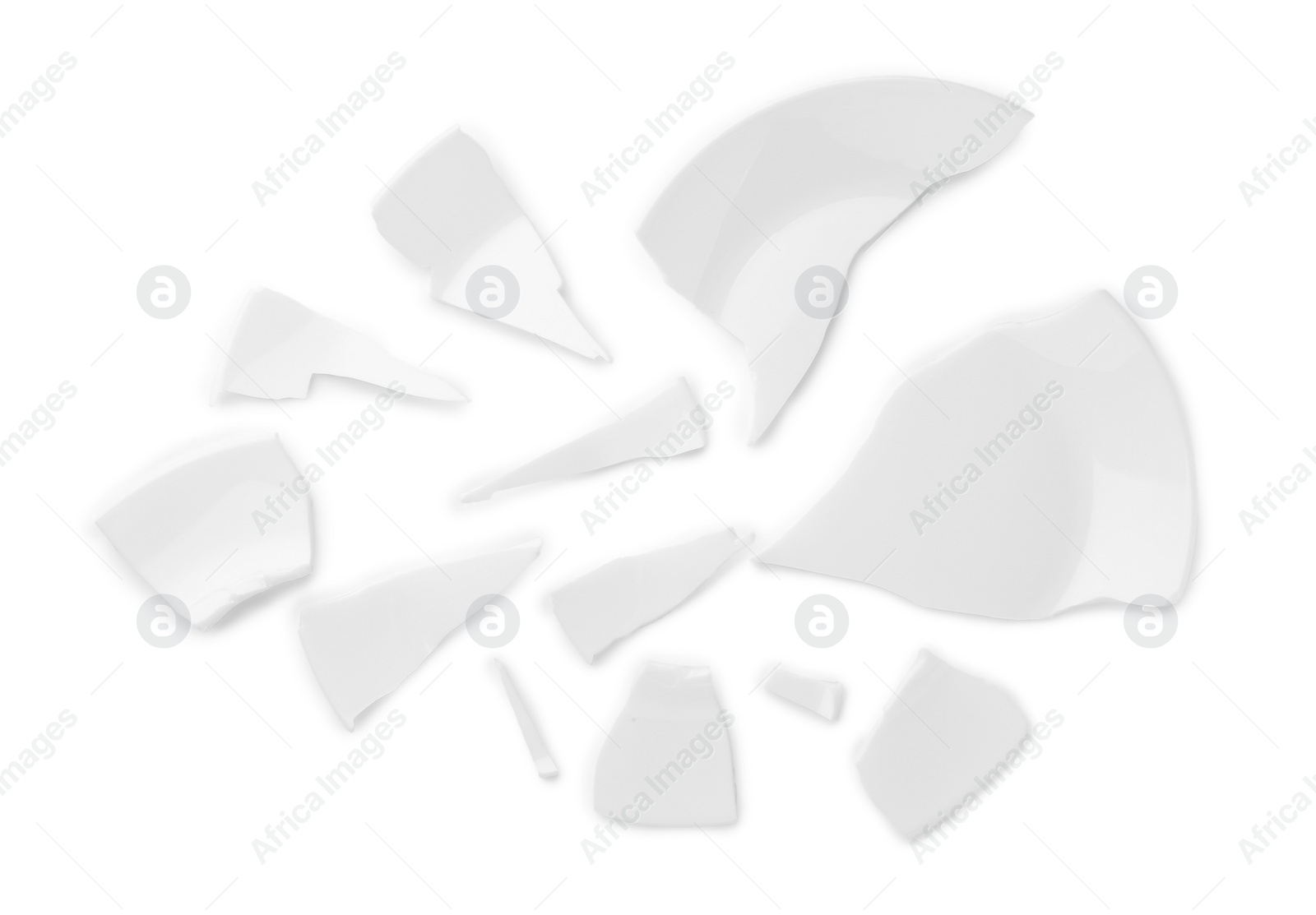 Photo of Pieces of broken ceramic plate on white background, top view