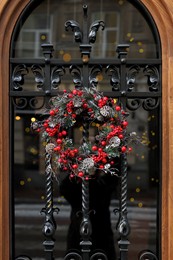 Beautiful Christmas wreath hanging on glass door