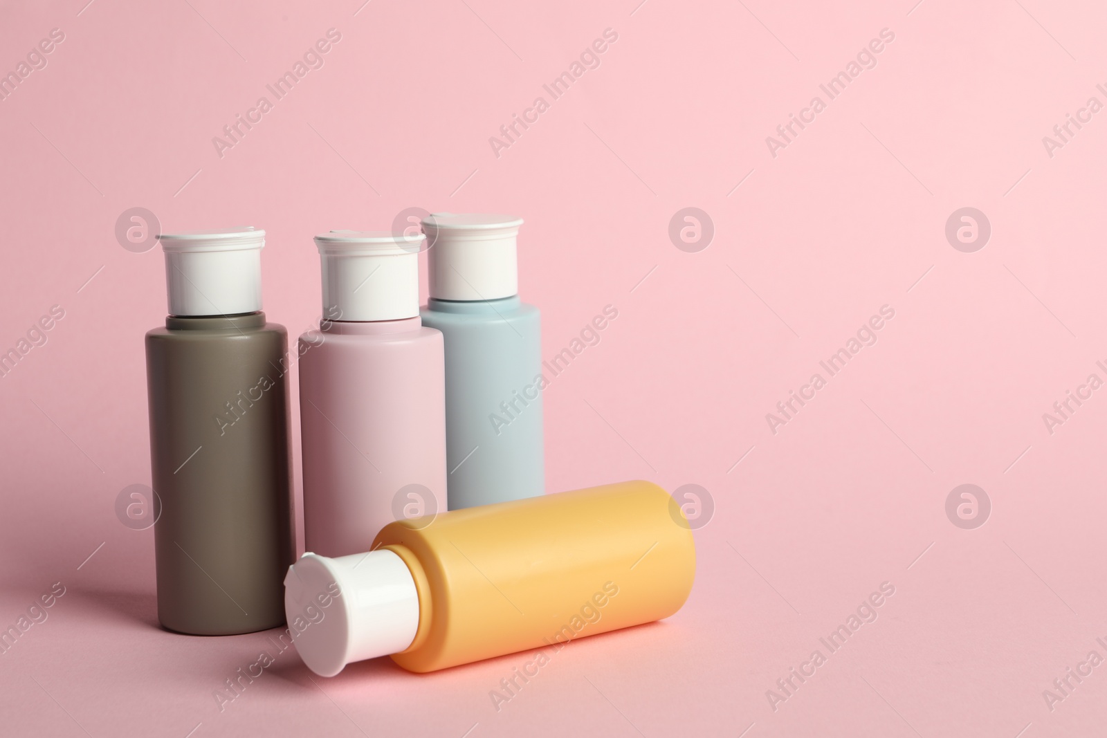 Photo of Cosmetic travel on pink background. Space for text