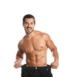 Photo of Young man with slim body in old big size jeans on white background