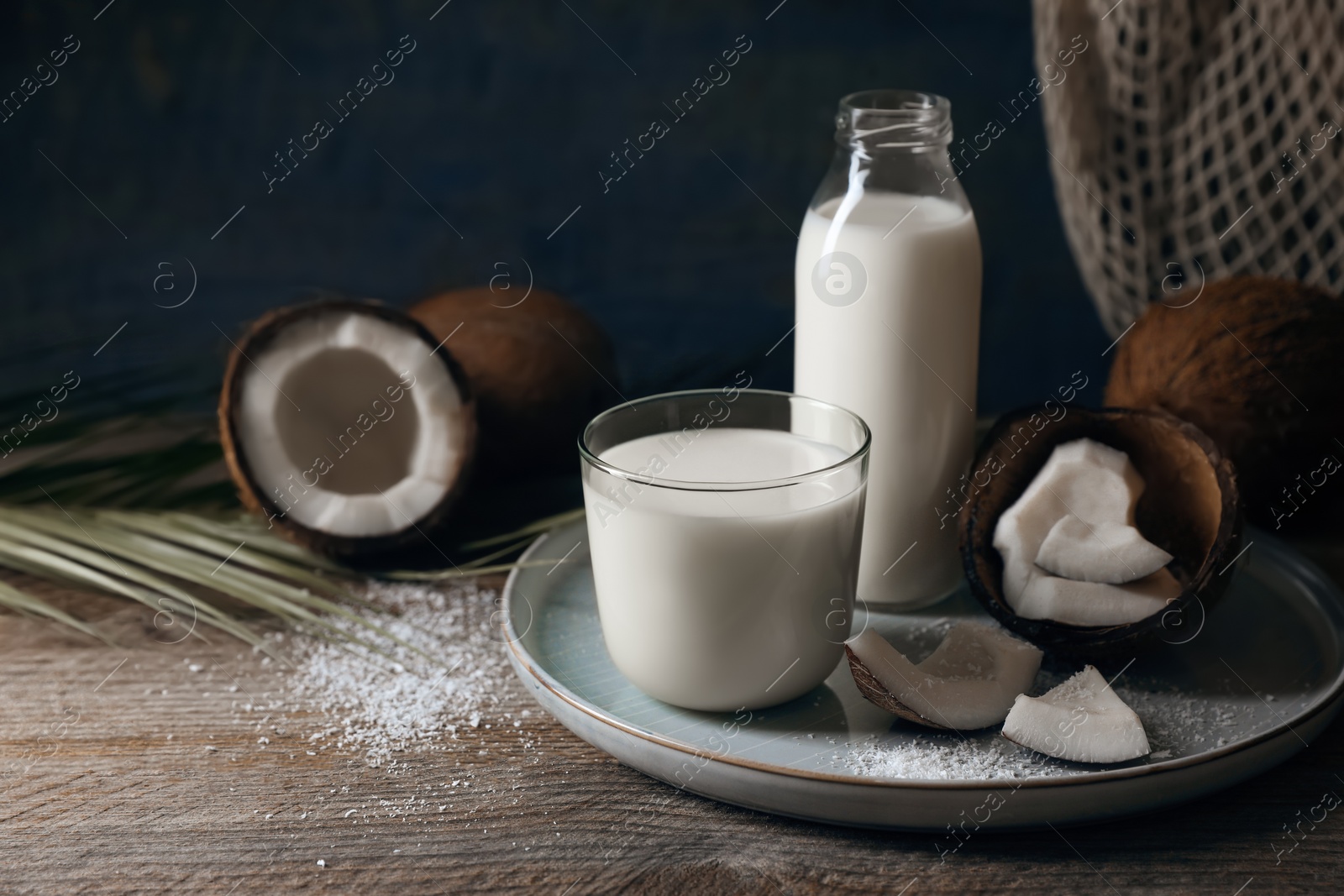 Photo of Composition with coconut milk on wooden table, space for text