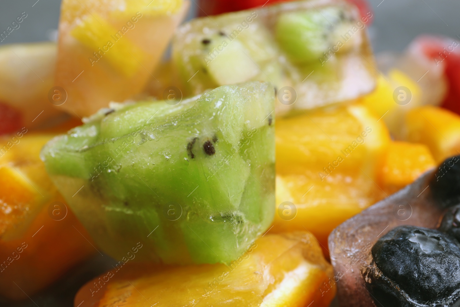 Photo of Fruit and berry ice cubes, closeup view