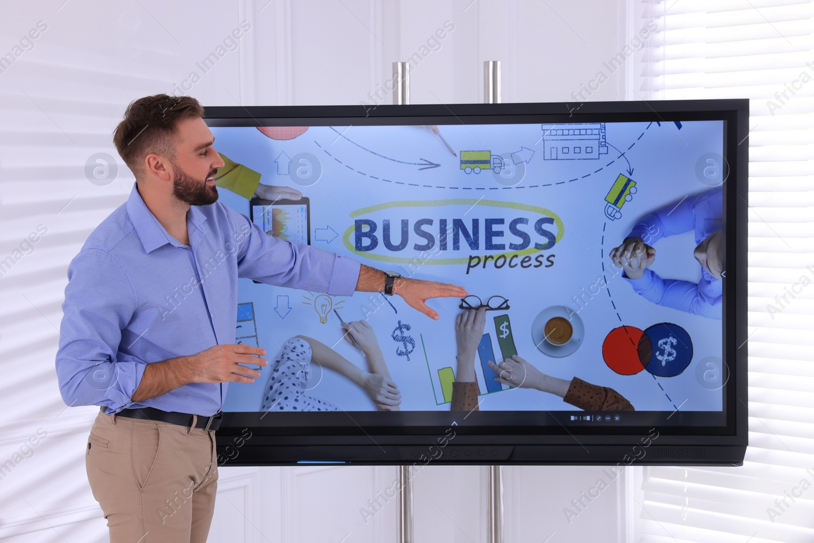 Photo of Business trainer using interactive board in meeting room