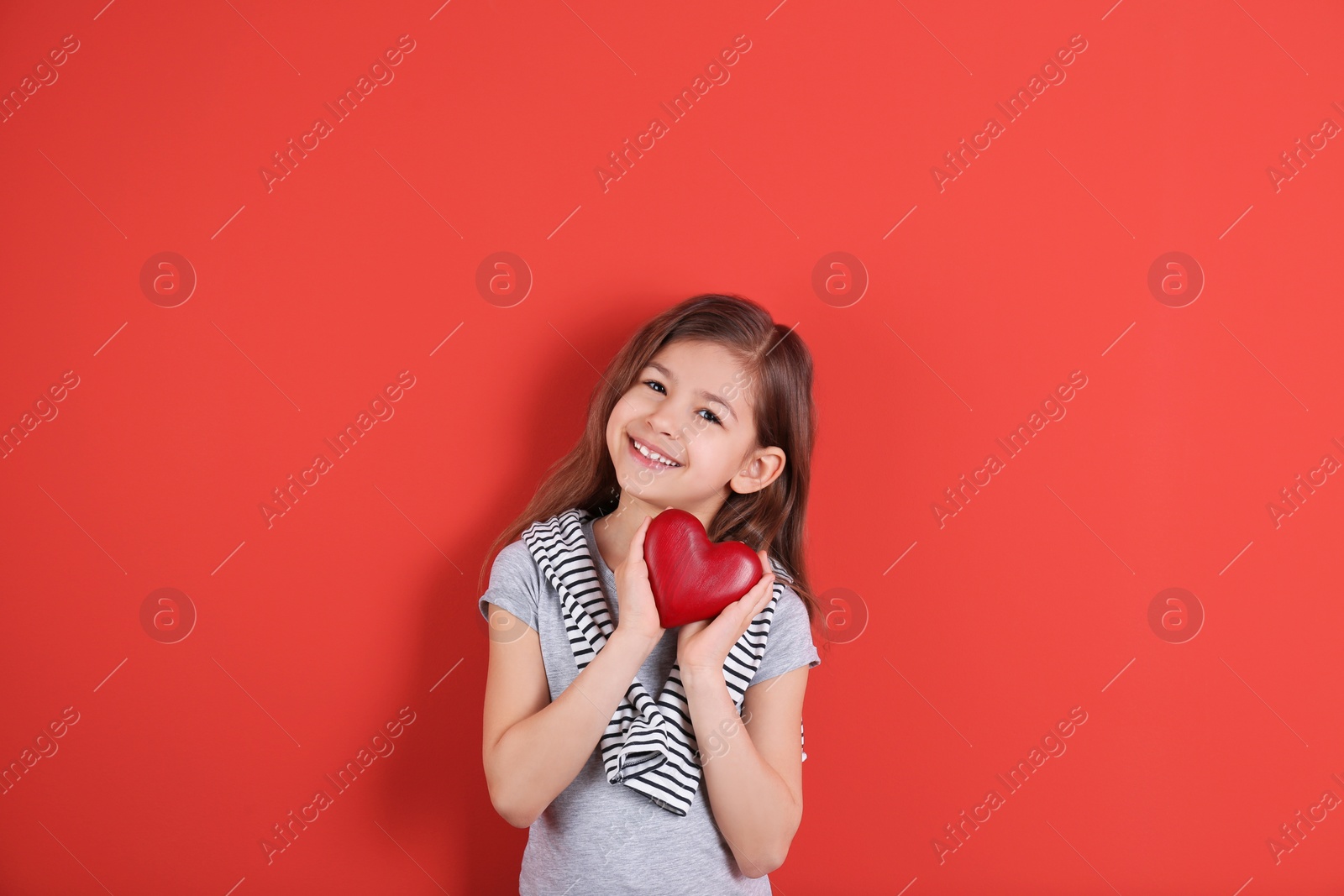 Photo of Portrait of girl with decorative heart on color background