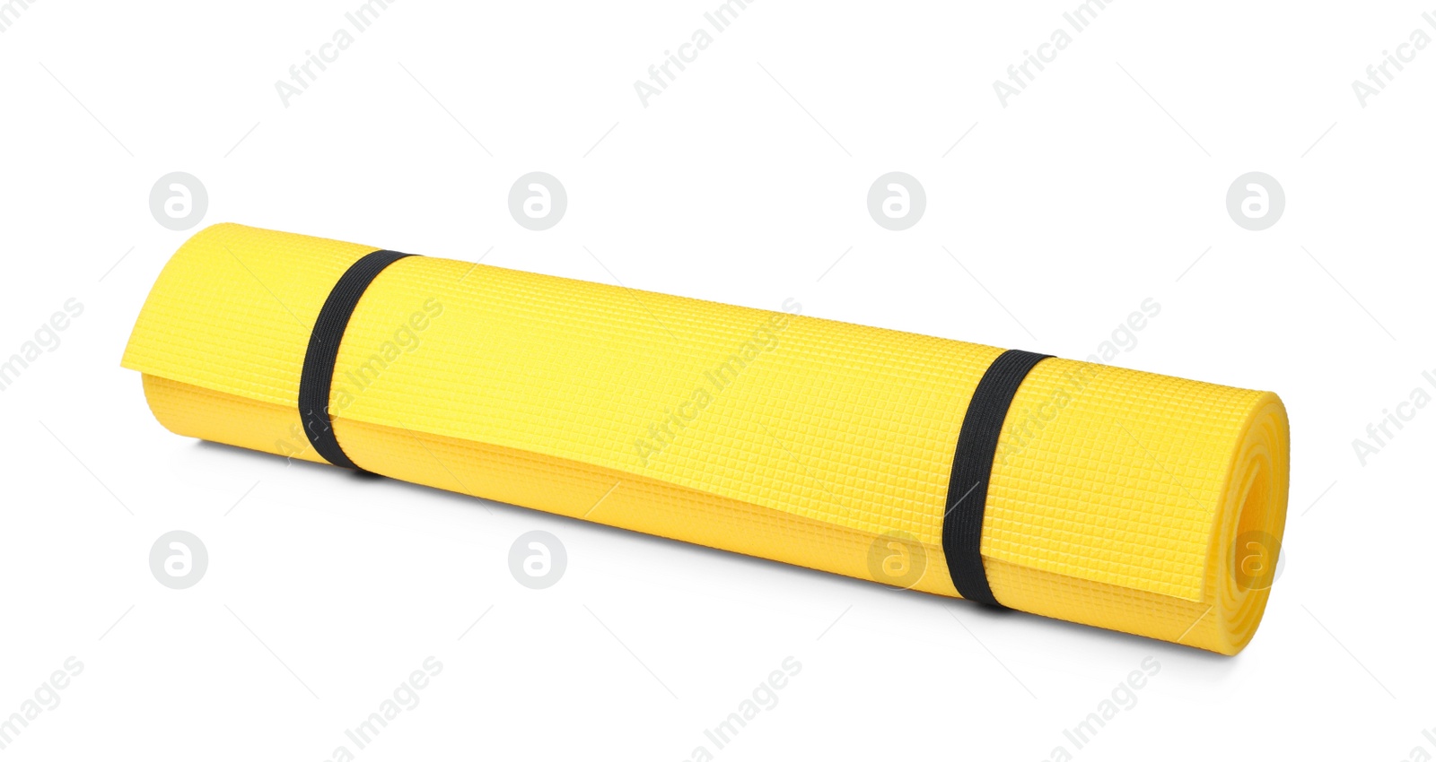 Photo of Yellow rolled mat isolated on white. Camping tourism equipment