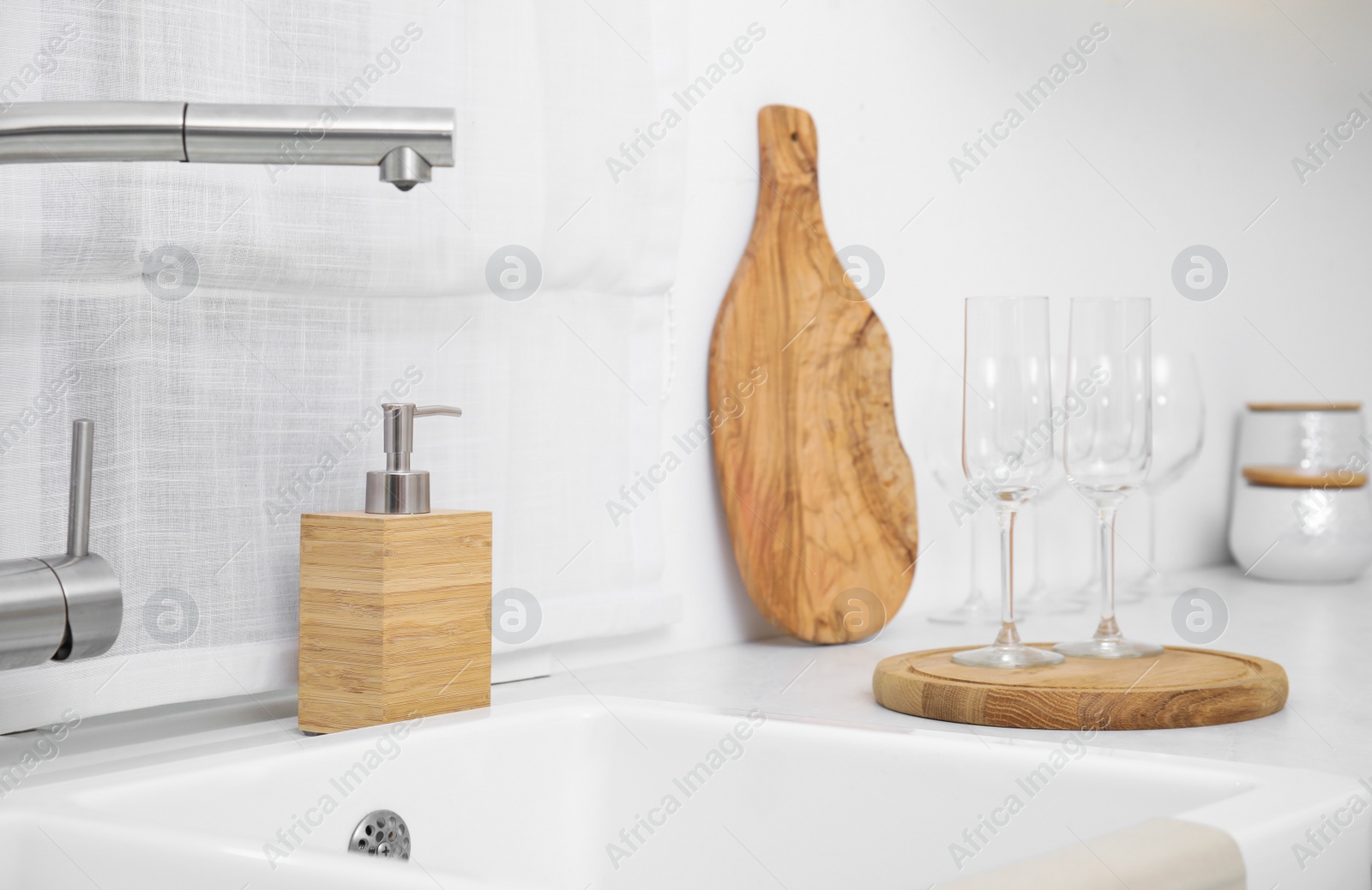 Photo of Kitchen counter with sink and clean glasses