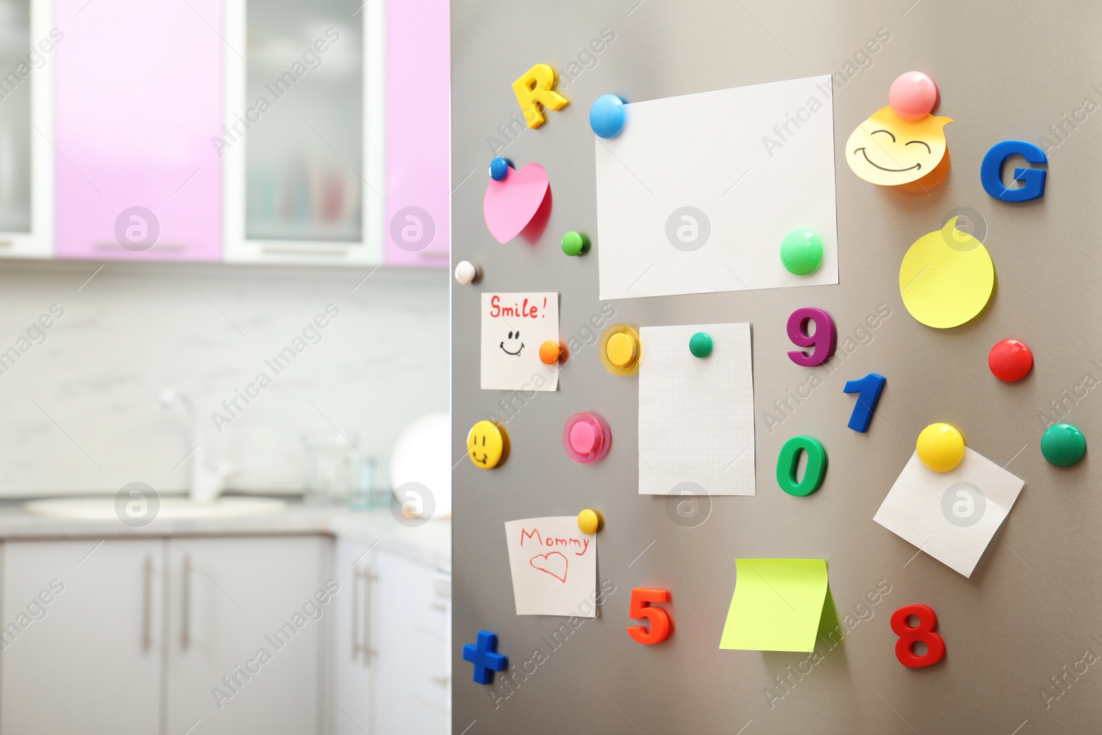 Photo of Many notes and empty sheets with magnets on refrigerator door in kitchen. Space for text