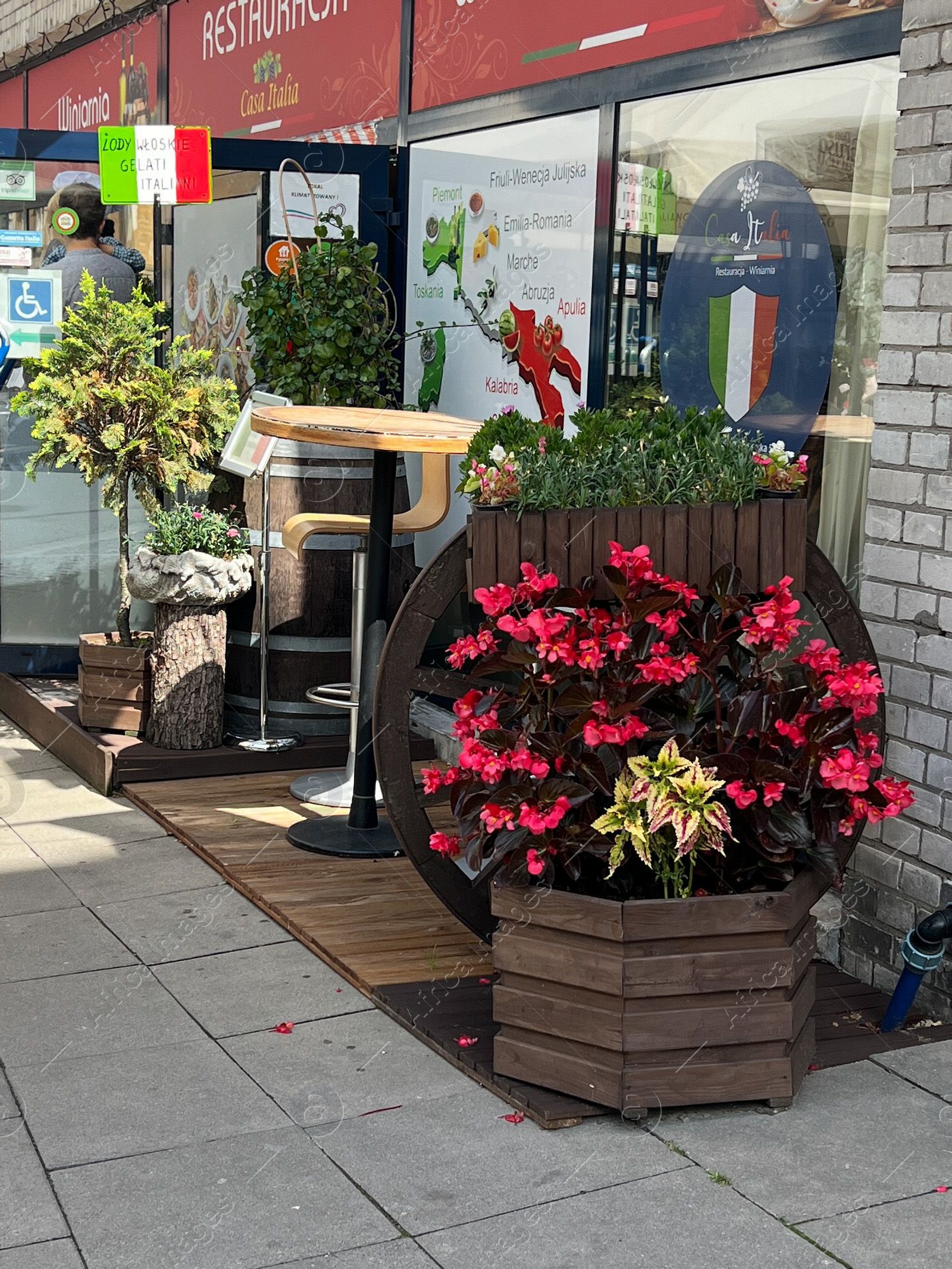 Photo of WARSAW, POLAND - JULY 17, 2022: Beautiful view of street with modern outdoor cafe and shops