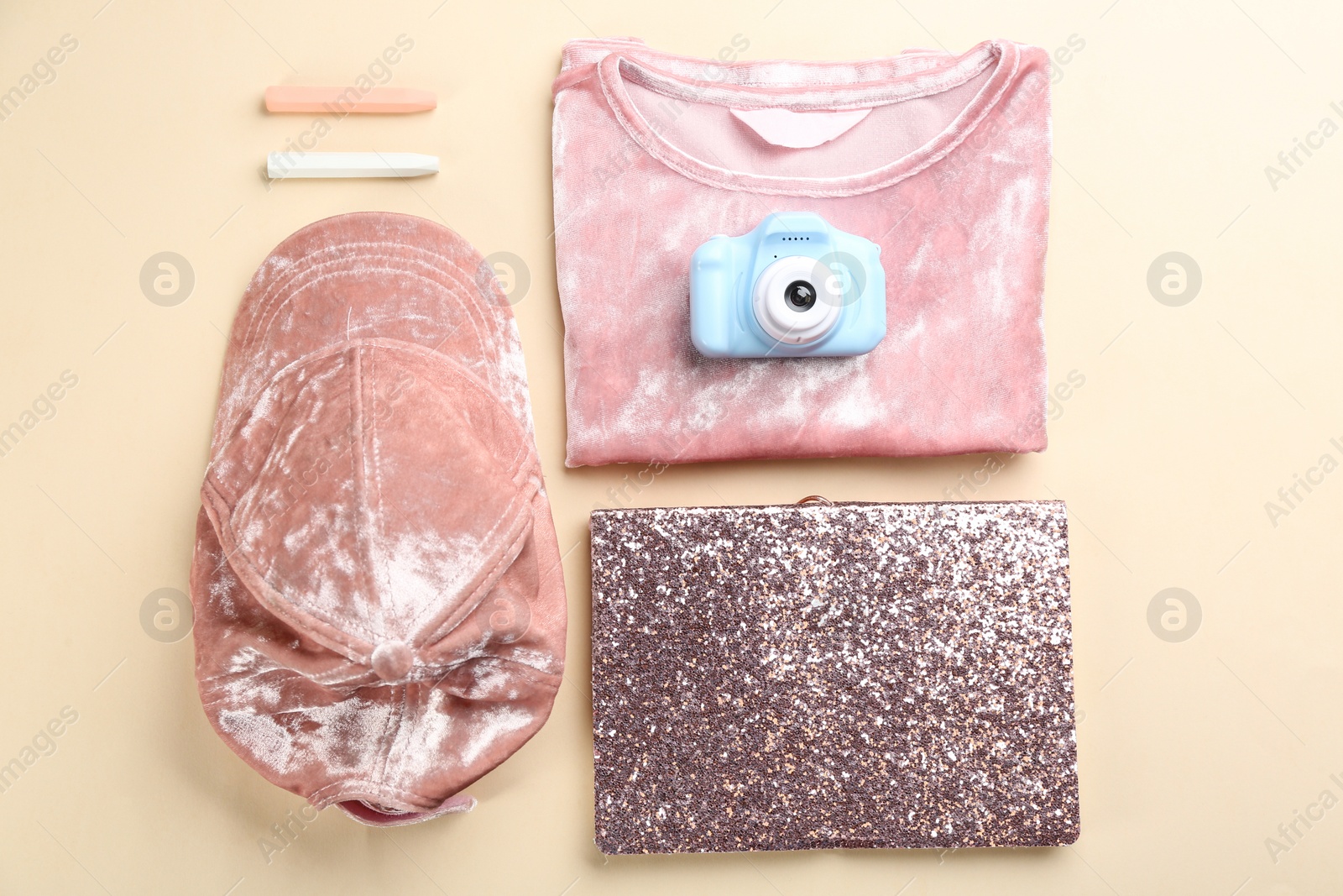 Photo of Flat lay composition with little photographer's toy camera on beige background