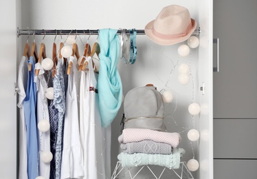 Photo of Women clothing on hangers in wardrobe