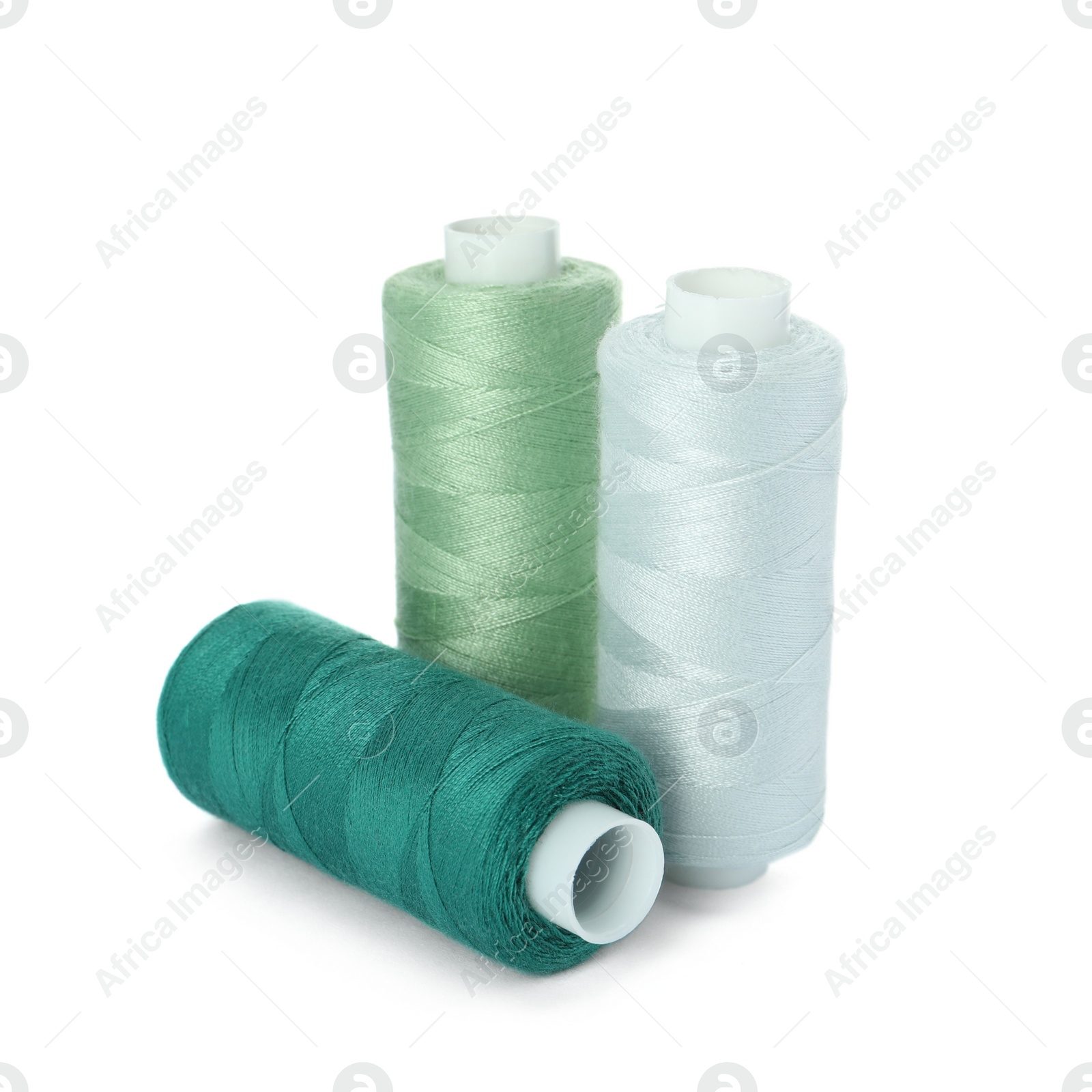 Photo of Different colorful sewing threads on white background