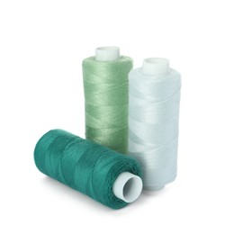 Photo of Different colorful sewing threads on white background