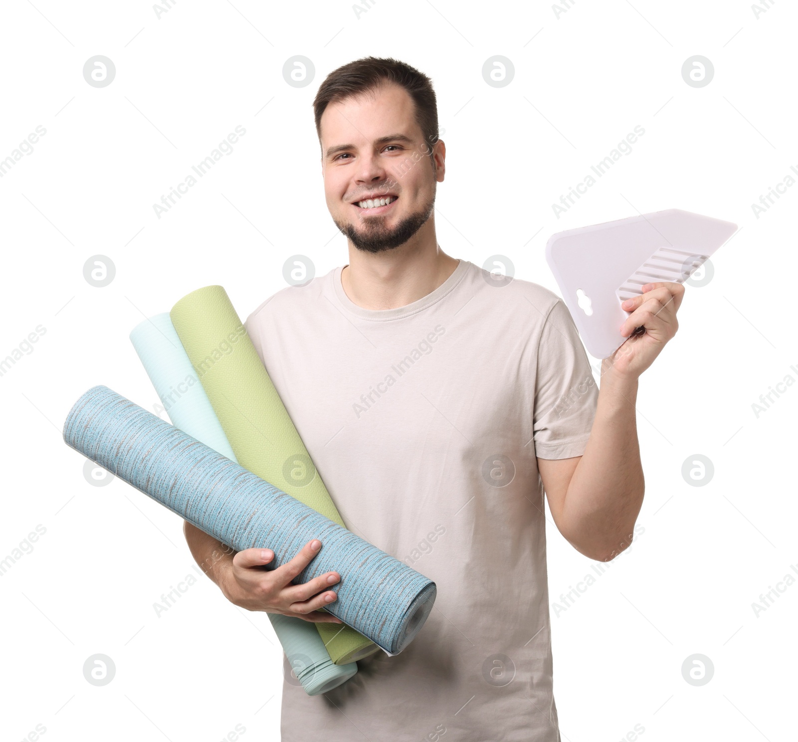 Photo of Man with wallpaper rolls and spatula on white background