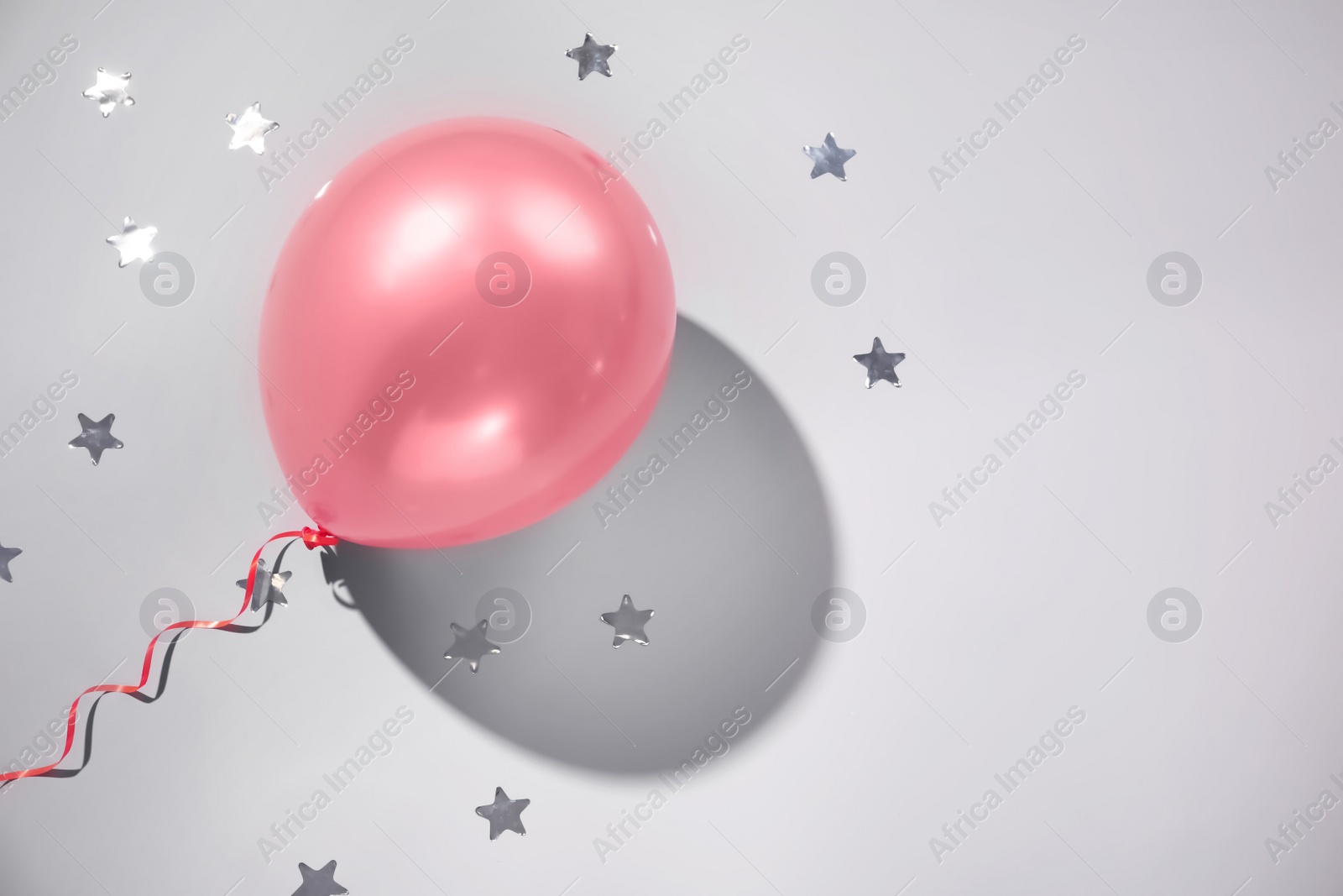 Photo of Festive balloon on grey background, top view. Space for text