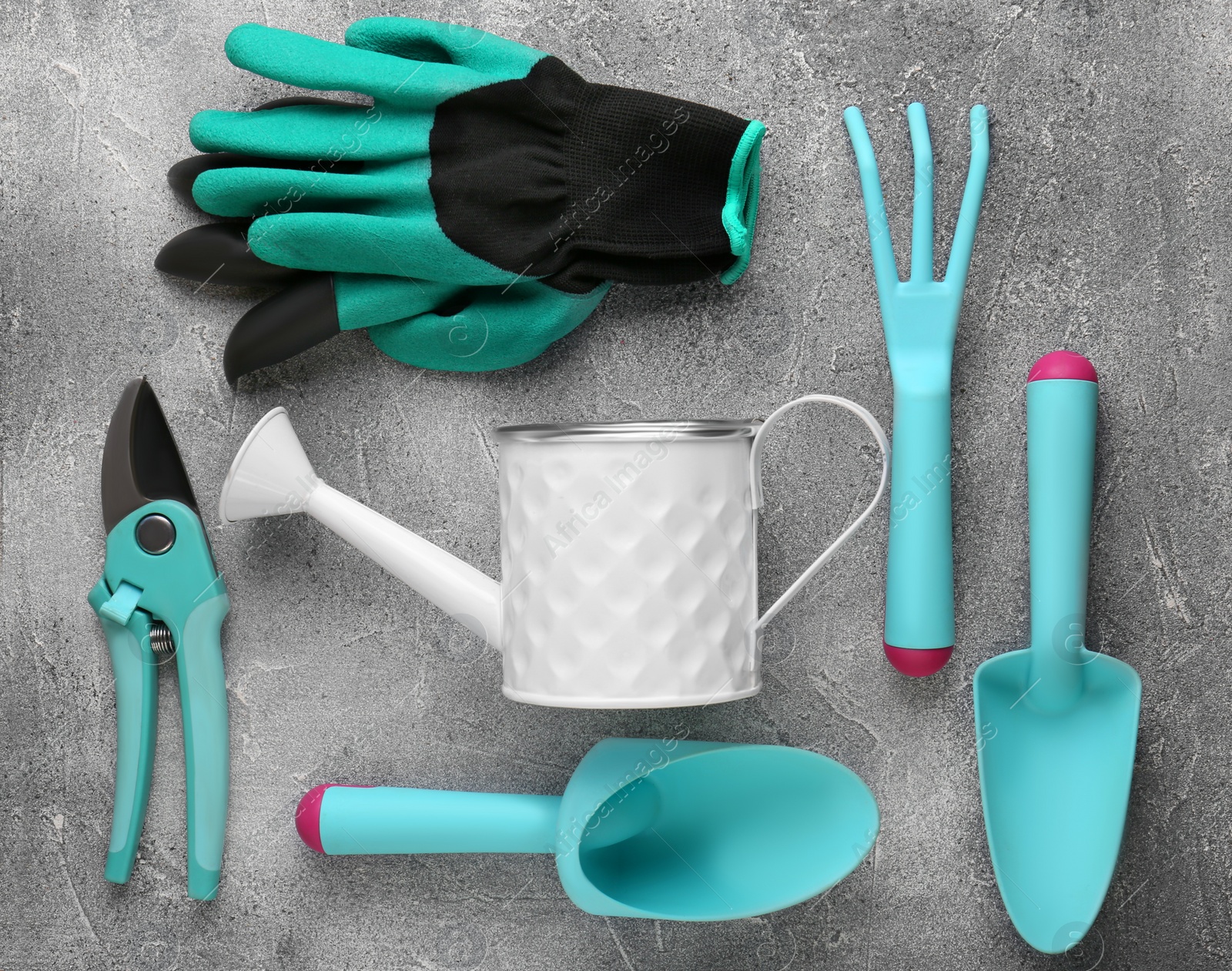 Photo of Flat lay composition with watering can and gardening tools on light grey background