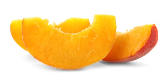 Slices of fresh sweet peach on white background