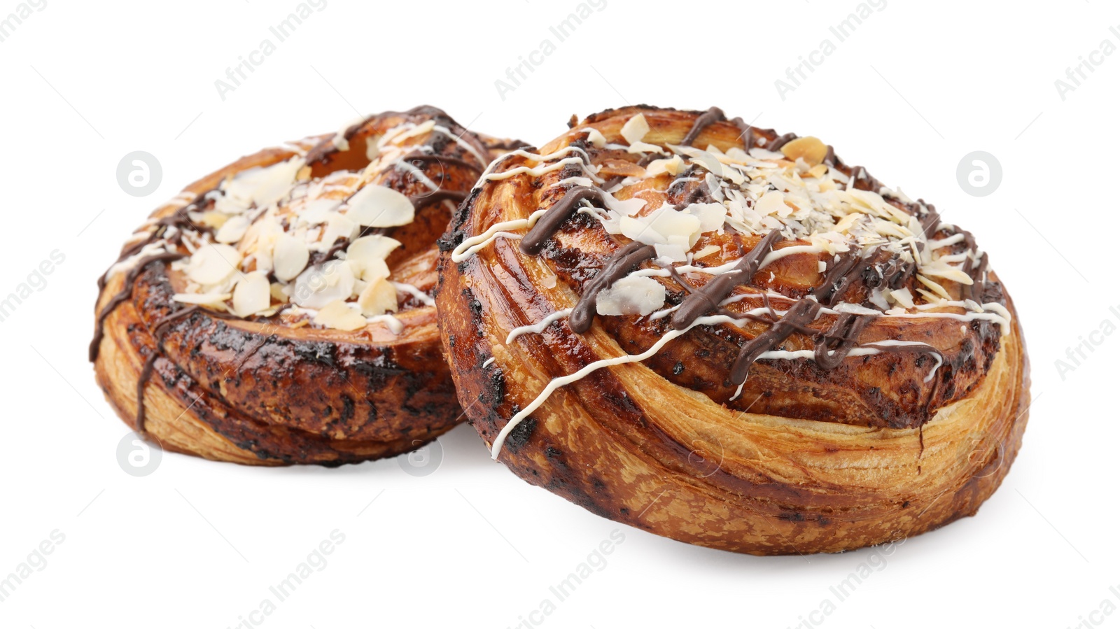 Photo of Delicious rolls with almond and toppings isolated on white. Sweet buns