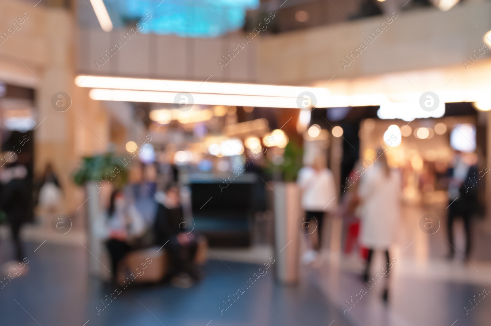 Photo of Blurred view of modern shopping mall interior