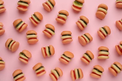 Photo of Tasty jelly candies in shape of burger on pink background, flat lay