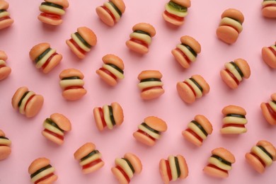 Tasty jelly candies in shape of burger on pink background, flat lay