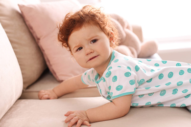 Photo of Portrait of cute little child on sofa at home