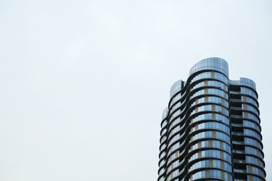 Photo of Low angle view of modern building with many windows against clear sky, space for text