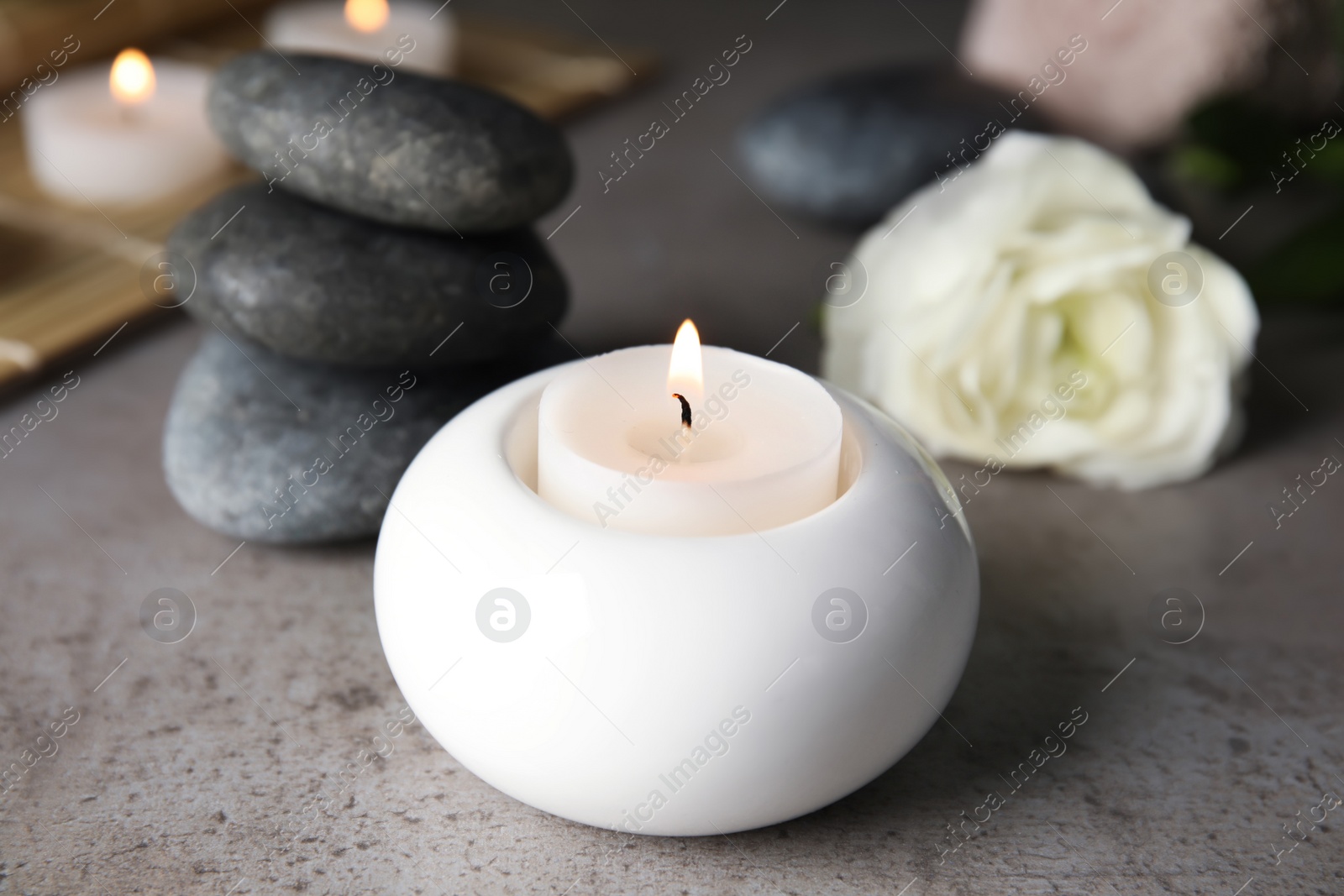 Photo of Spa composition with burning candle on table