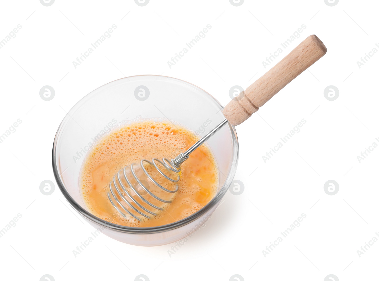 Photo of Beaten eggs and whisk in glass bowl isolated on white