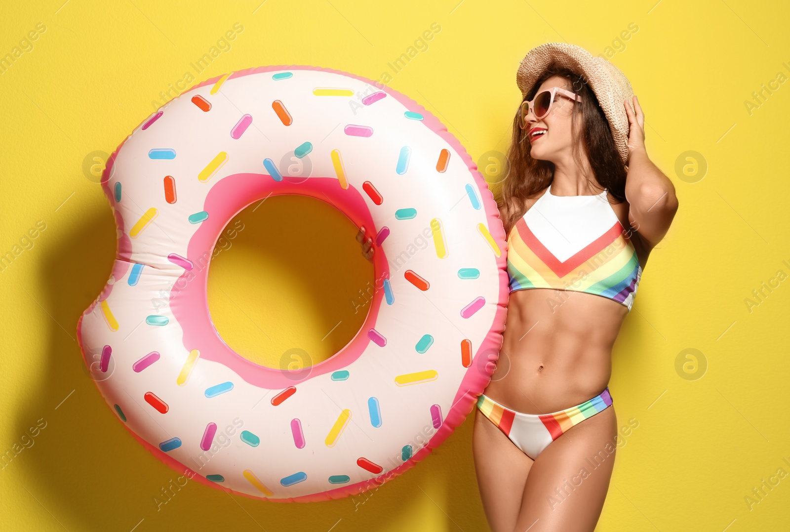 Photo of Beautiful young woman with inflatable ring on color background