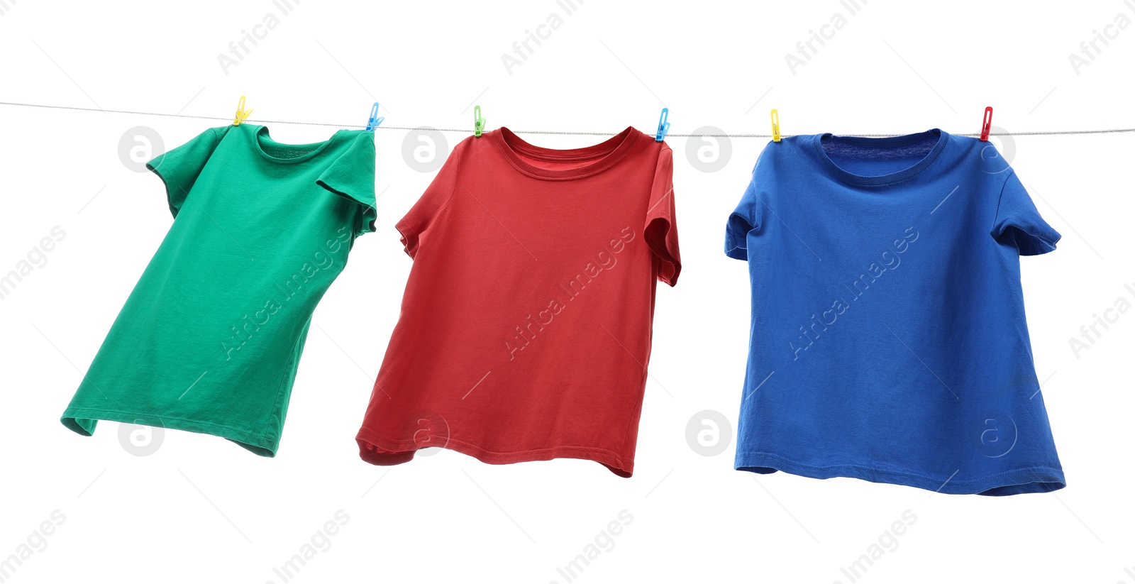 Photo of Colorful t-shirts drying on washing line isolated on white