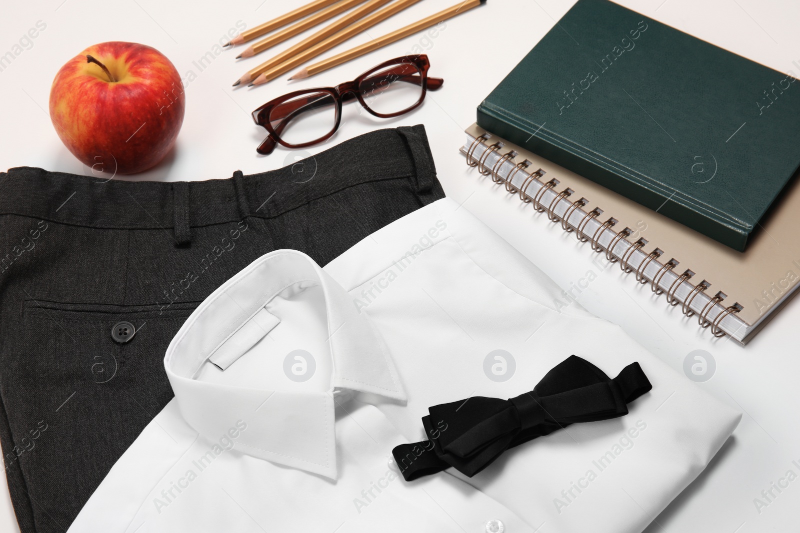 Photo of School uniform for boy and stationery on white background