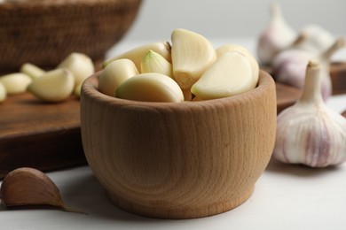 Fresh organic garlic on white table, closeup