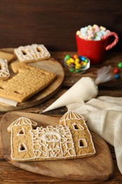 Parts of gingerbread house on wooden table