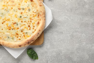 Delicious cheese pizza on light grey table, top view. Space for text