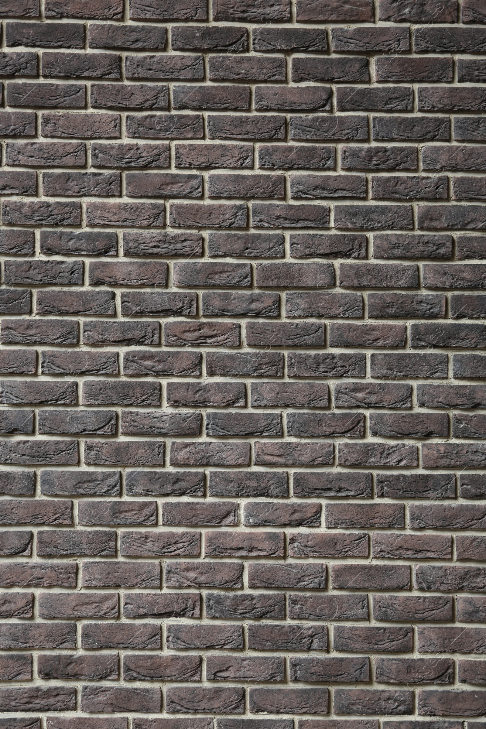 Photo of Texture of brown brick wall as background, closeup