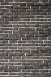 Photo of Texture of brown brick wall as background, closeup