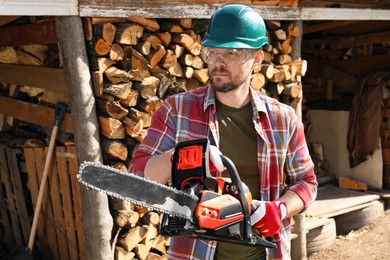 Man with modern saw on sunny day