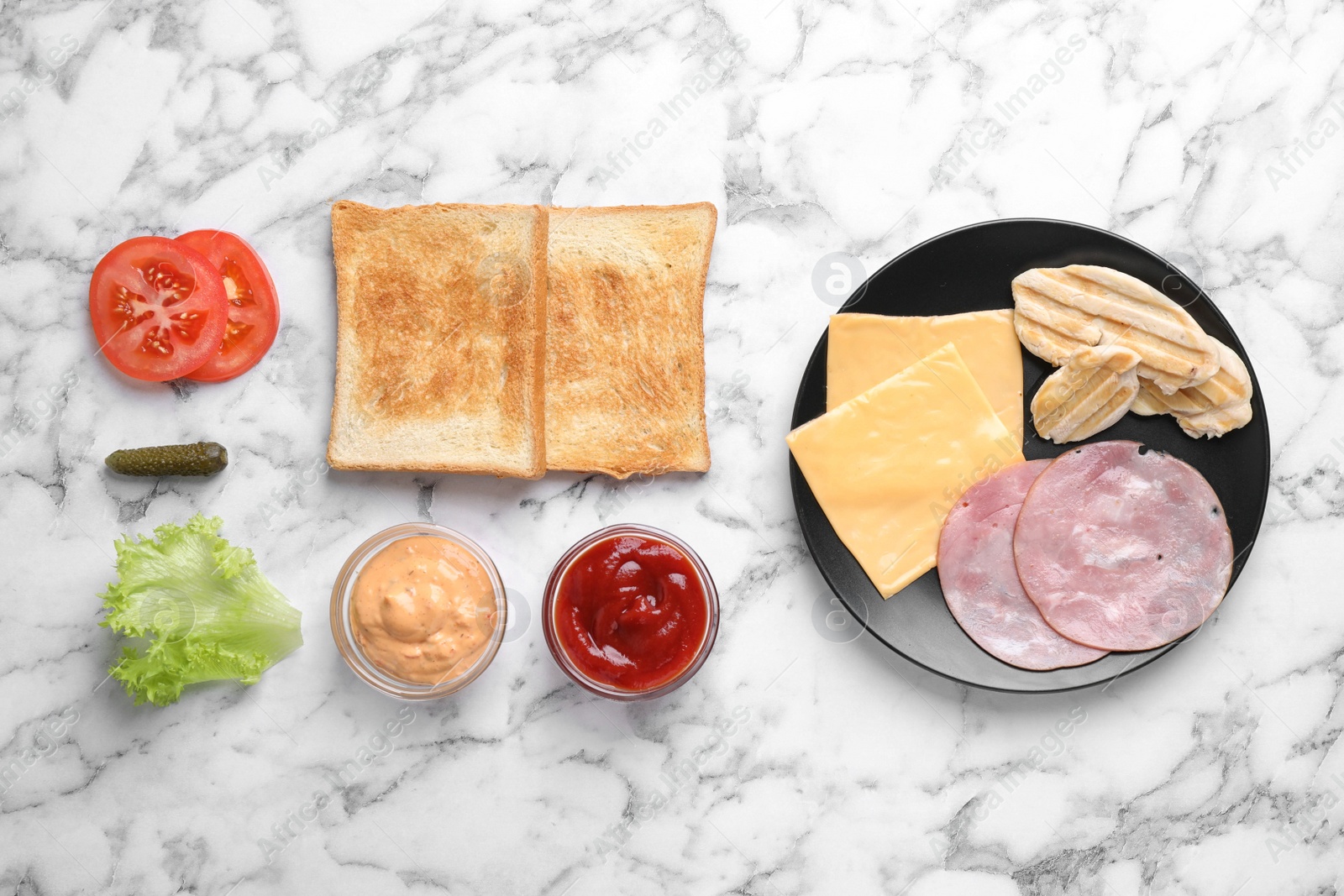 Photo of Fresh ingredients for tasty sandwich on white marble background, flat lay