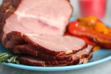 Photo of Cut delicious ham with rosemary on plate, closeup