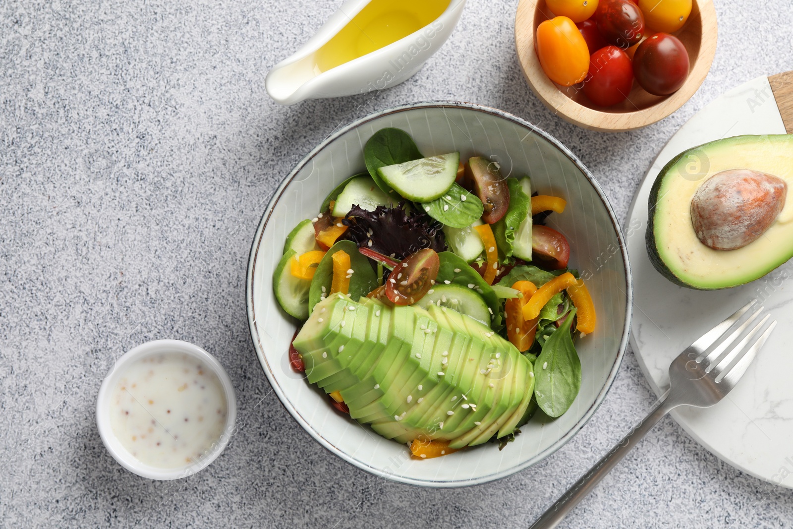 Photo of Healthy dish high in vegetable fats served on light textured table, flat lay