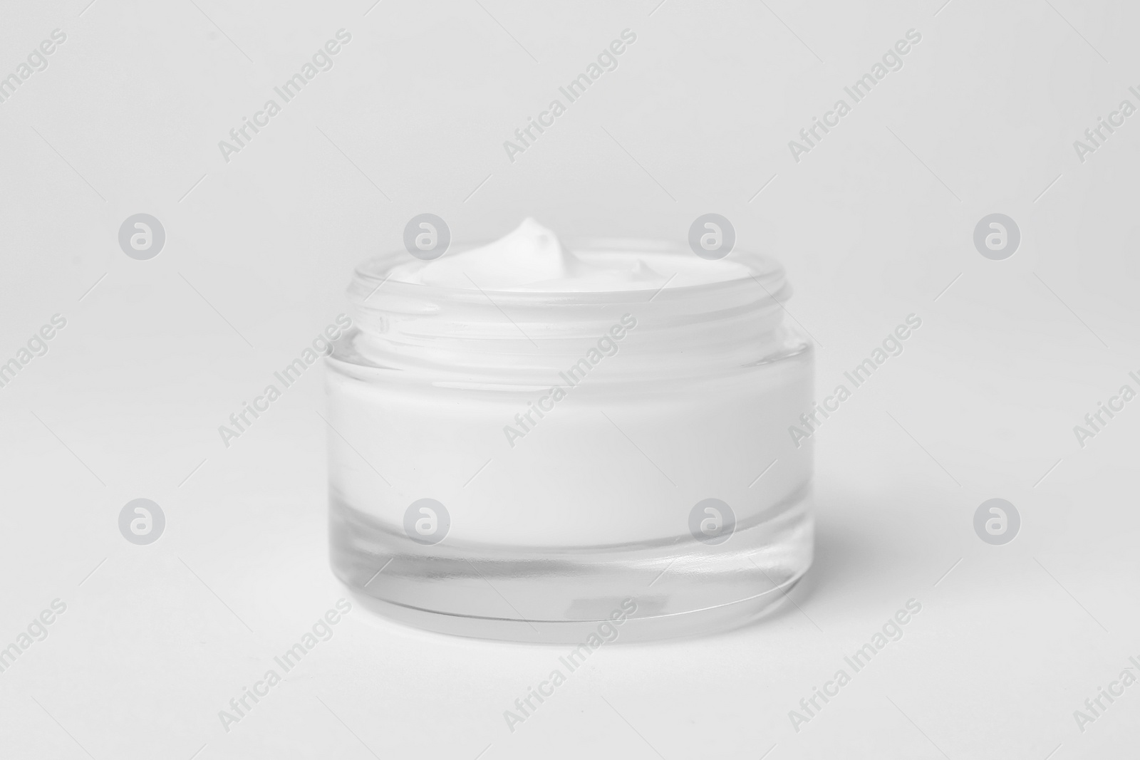 Photo of Jar of cosmetic product on light background