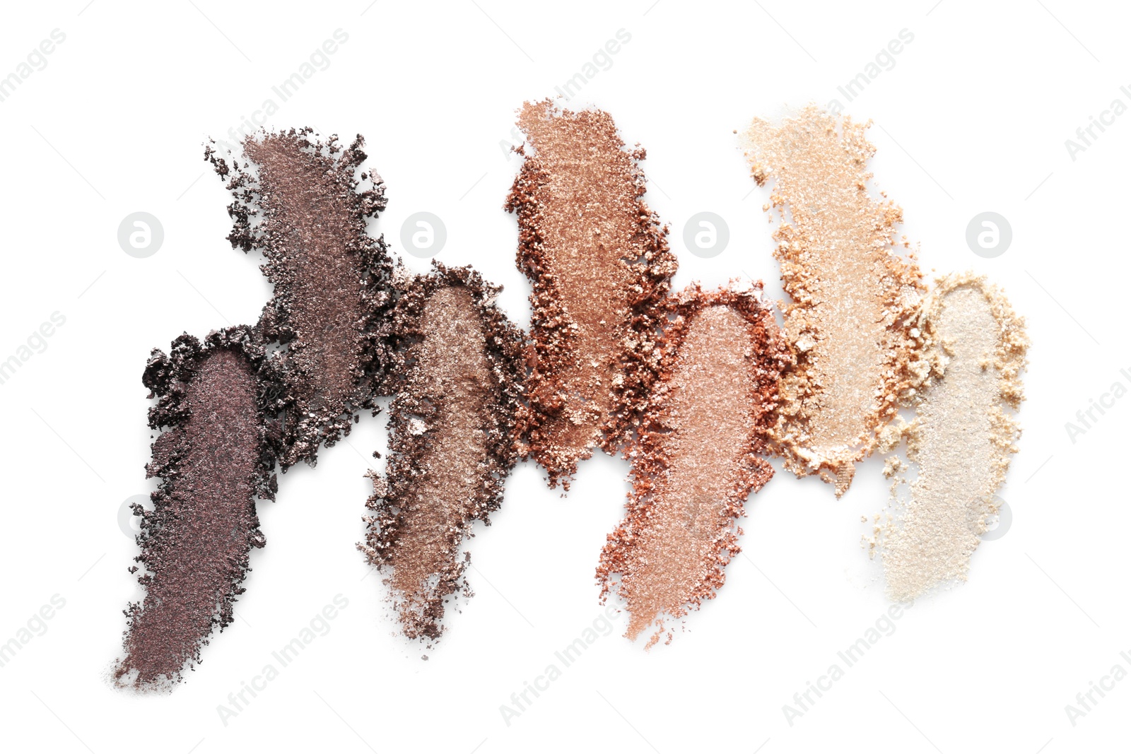 Photo of Crushed eye shadows on white background. Professional makeup products