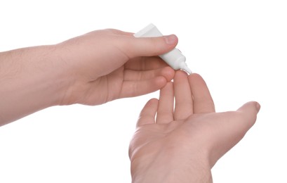 Photo of Man applying ointment from tube onto his hand on white background, closeup