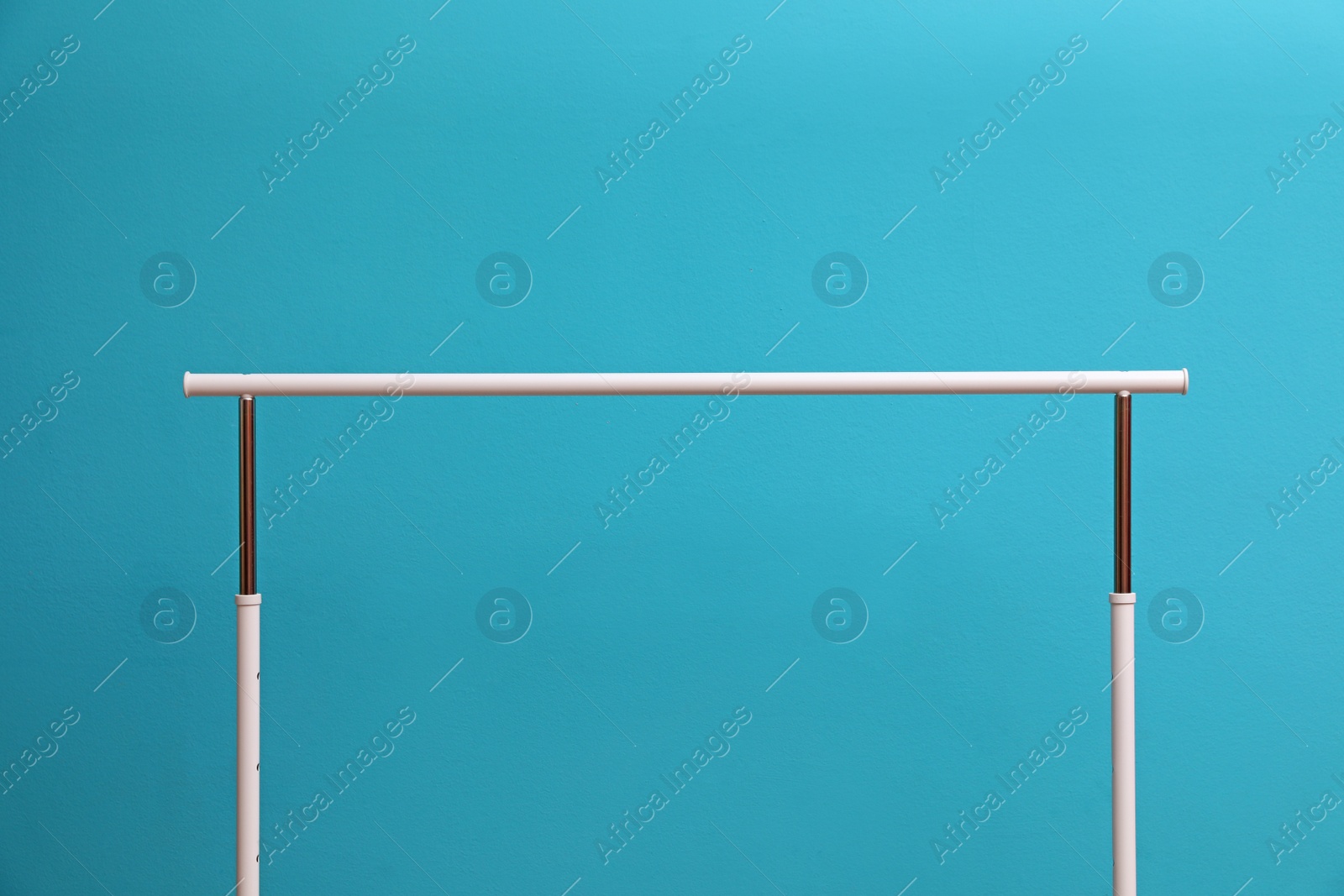 Photo of Empty wardrobe rack for clothing on color background