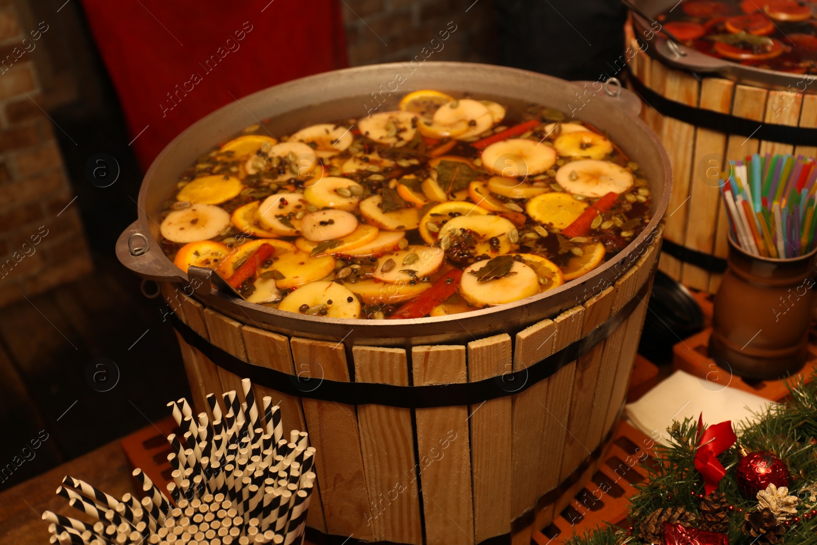 Photo of Large cauldron with tasty mulled wine at winter fair