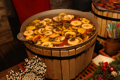 Large cauldron with tasty mulled wine at winter fair